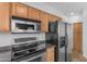 This kitchen showcases stainless steel appliances, including a microwave, stove, and refrigerator at 2402 E 5Th St # 1621, Tempe, AZ 85288