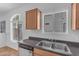 Well-lit kitchen with a stainless steel sink, wood cabinets, stainless steel dishwasher, and a window at 2402 E 5Th St # 1621, Tempe, AZ 85288