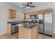 Spacious kitchen with a stainless steel refrigerator, center island, and plenty of cabinet storage at 2402 E 5Th St # 1621, Tempe, AZ 85288