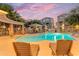 Relaxing community pool with lounge chairs and shaded seating area at dusk at 2402 E 5Th St # 1621, Tempe, AZ 85288