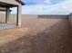 Large, bare backyard with a covered patio area, perfect for customization at 25151 W Wayland Dr, Buckeye, AZ 85326
