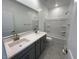 Elegant bathroom with double sinks, quartz countertops, and bathtub with shower at 25151 W Wayland Dr, Buckeye, AZ 85326