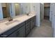 Modern bathroom with double sinks and walk-in shower, providing a luxurious experience at 25151 W Wayland Dr, Buckeye, AZ 85326