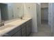 Bathroom featuring a double sink vanity, modern fixtures, and a walk-in closet at 25151 W Wayland Dr, Buckeye, AZ 85326