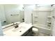 Bright bathroom featuring a single vanity with a quartz countertop and a bathtub-shower combination at 25151 W Wayland Dr, Buckeye, AZ 85326