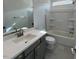 Well-lit bathroom featuring a modern vanity, toilet, and shower-tub combo at 25151 W Wayland Dr, Buckeye, AZ 85326