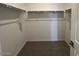 Walk-in closet with metal rods, providing storage solutions and organization at 25151 W Wayland Dr, Buckeye, AZ 85326