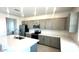 Modern kitchen featuring gray cabinets, stainless steel appliances, subway tile backsplash and a spacious white countertop island at 25151 W Wayland Dr, Buckeye, AZ 85326