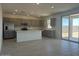 Modern kitchen featuring stainless steel appliances, an island, and sliding doors to the backyard at 25151 W Wayland Dr, Buckeye, AZ 85326