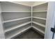 Spacious pantry with ample shelving for organized storage solutions in this modern home at 25151 W Wayland Dr, Buckeye, AZ 85326