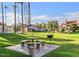 Community grilling area with stone table and benches under mature trees at 30 E Brown Rd # 1048, Mesa, AZ 85201
