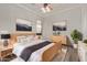 Cozy bedroom featuring hardwood floors, neutral paint, and a decorative ceiling fan with light fixtures at 3437 E Kingbird Pl, Chandler, AZ 85286