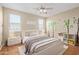 Bright bedroom with light walls, hardwood floors, a ceiling fan, and tree decals at 3437 E Kingbird Pl, Chandler, AZ 85286