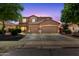 Charming two-story home with a three car garage, lush landscaping, and a welcoming facade at 3437 E Kingbird Pl, Chandler, AZ 85286
