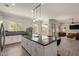 Open kitchen with a central island, stainless appliances, and hardwood flooring at 3437 E Kingbird Pl, Chandler, AZ 85286
