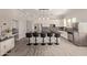 A modern kitchen with stainless steel appliances, an island with seating, and white cabinetry at 3437 E Kingbird Pl, Chandler, AZ 85286