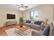 Cozy living room with plush seating, modern decor, and a bright window for natural light at 3437 E Kingbird Pl, Chandler, AZ 85286