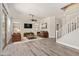 Bright living room with hardwood floors, a ceiling fan, and a view of the staircase at 3437 E Kingbird Pl, Chandler, AZ 85286