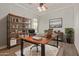 Office area with a large desk, wooden floors, a book shelf, and a chair at 3437 E Kingbird Pl, Chandler, AZ 85286