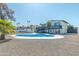 Expansive backyard with a large pool, deck, and detached garage at 4530 W Paradise Dr, Glendale, AZ 85304