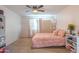 Bright bedroom with pink accents and built-in shelving for storage at 4530 W Paradise Dr, Glendale, AZ 85304