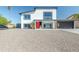 Stunning two-story home with a red front door and desert landscaping at 4530 W Paradise Dr, Glendale, AZ 85304