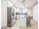 Well-lit kitchen with an island, stainless steel appliances, and white cabinets at 4530 W Paradise Dr, Glendale, AZ 85304