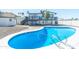 Inground pool with a white tile surround and a view of the backyard deck at 4530 W Paradise Dr, Glendale, AZ 85304