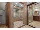 Beautifully tiled bathroom featuring a glass enclosed shower with glass block window and a large sliding glass door to vanity at 5008 E Nisbet Rd, Scottsdale, AZ 85254
