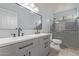 Modern bathroom with a double vanity, a large mirror, updated lighting and a glass enclosed shower at 5008 E Nisbet Rd, Scottsdale, AZ 85254