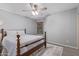 Cozy bedroom with wood-look floors, a ceiling fan, a window with blinds, and a traditional wood frame bed at 5008 E Nisbet Rd, Scottsdale, AZ 85254