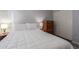 Cozy bedroom with a wooden dresser, soft lighting, white trim, and a white bed at 5008 E Nisbet Rd, Scottsdale, AZ 85254