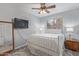 Bright bedroom with gray walls, wood-look floors, a window with blinds, and wall mounted TV at 5008 E Nisbet Rd, Scottsdale, AZ 85254