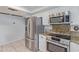 This kitchen is equipped with stainless steel appliances and white cabinets at 5008 E Nisbet Rd, Scottsdale, AZ 85254