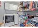 Functional laundry room and pantry area with plentiful storage, washer, dryer, and wire shelving at 5008 E Nisbet Rd, Scottsdale, AZ 85254