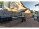 Built-in outdoor kitchen featuring a stone countertop and a convenient grill at 5008 E Nisbet Rd, Scottsdale, AZ 85254