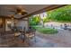 Inviting covered outdoor patio, complete with wrought iron furniture and a view of the pool and backyard oasis at 5008 E Nisbet Rd, Scottsdale, AZ 85254