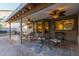 Relaxing outdoor patio area with ceiling fans, ambient lighting, and wrought iron furniture at 5008 E Nisbet Rd, Scottsdale, AZ 85254