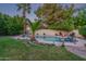 Expansive pool area with tropical landscaping, firepit and waterfall creating a relaxing atmosphere at 5008 E Nisbet Rd, Scottsdale, AZ 85254