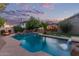 Stunning backyard pool with mature landscaping, waterfall feature, and lounge chairs at 5008 E Nisbet Rd, Scottsdale, AZ 85254