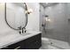 Modern bathroom features dark vanity, marble countertop, and glass enclosed shower at 6202 E Larkspur Dr, Scottsdale, AZ 85254