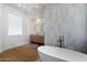 Bright bathroom boasts wood floors, double vanity, soaking tub and tiled shower at 6202 E Larkspur Dr, Scottsdale, AZ 85254
