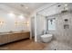 Luxurious bathroom featuring dual vanities, soaking tub, and glass enclosed shower at 6202 E Larkspur Dr, Scottsdale, AZ 85254