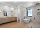 Bright bathroom boasts wood floors, double vanity, soaking tub and tiled shower at 6202 E Larkspur Dr, Scottsdale, AZ 85254