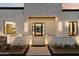 Close-up of the home's entrance featuring a stone-accented walkway and modern lighting fixtures at 6202 E Larkspur Dr, Scottsdale, AZ 85254