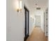 Hallway featuring recessed lighting, dark wood doors, sconces, and hardwood flooring at 6202 E Larkspur Dr, Scottsdale, AZ 85254