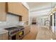 Chef's kitchen with stainless appliances, stone backsplash, and wood cabinetry at 6202 E Larkspur Dr, Scottsdale, AZ 85254