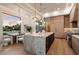 Modern kitchen showcasing a large island, stylish pendant lighting, and views of the outdoors at 6202 E Larkspur Dr, Scottsdale, AZ 85254