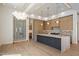 Spacious kitchen featuring modern appliances, stylish lighting, and a unique wine storage display at 6202 E Larkspur Dr, Scottsdale, AZ 85254