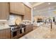 Gourmet kitchen with a Wolf range, marble backsplash, and seamless flow into the living area at 6202 E Larkspur Dr, Scottsdale, AZ 85254